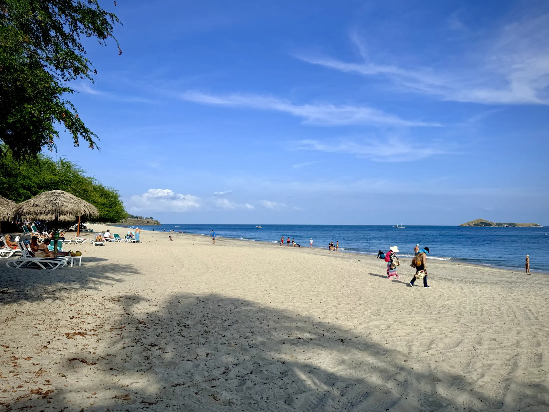 Sandy beach with blue ocean waters and Farallón Island on the horizon