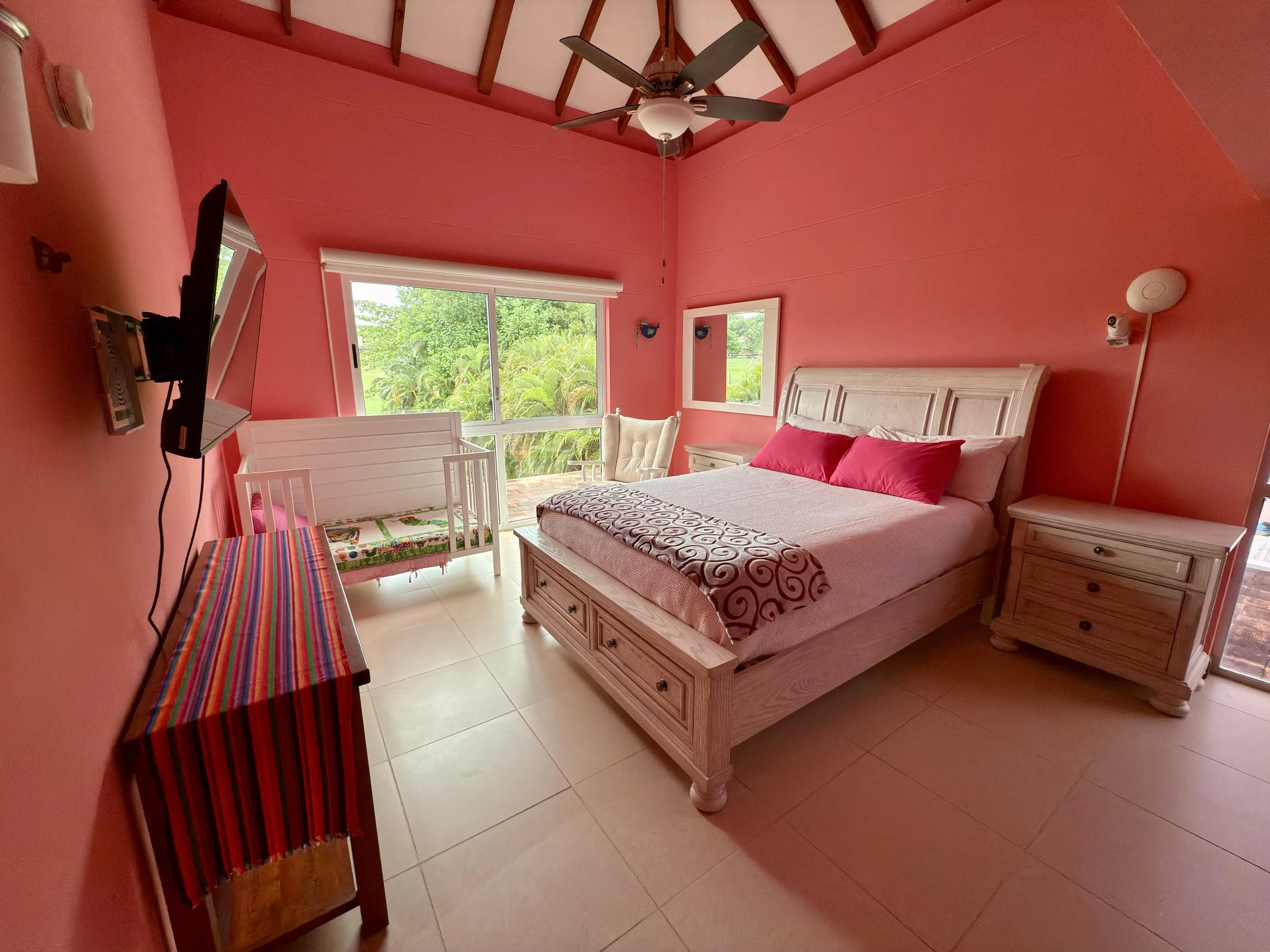 Pink bedroom alternate angle with vaulted ceiling, white furniture, and pink accent pillows